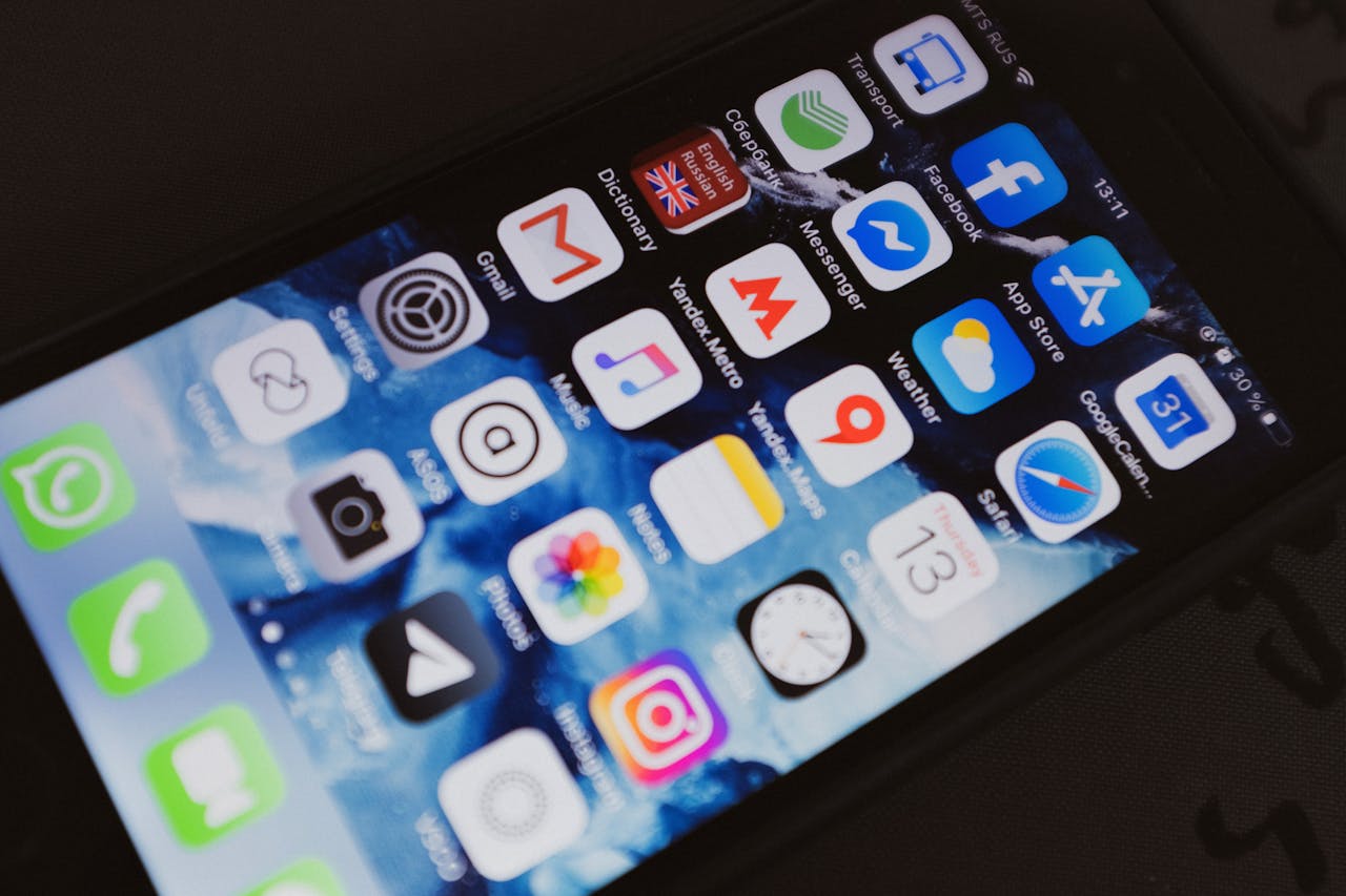 Close-up of a smartphone displaying popular social media and productivity apps on its screen.